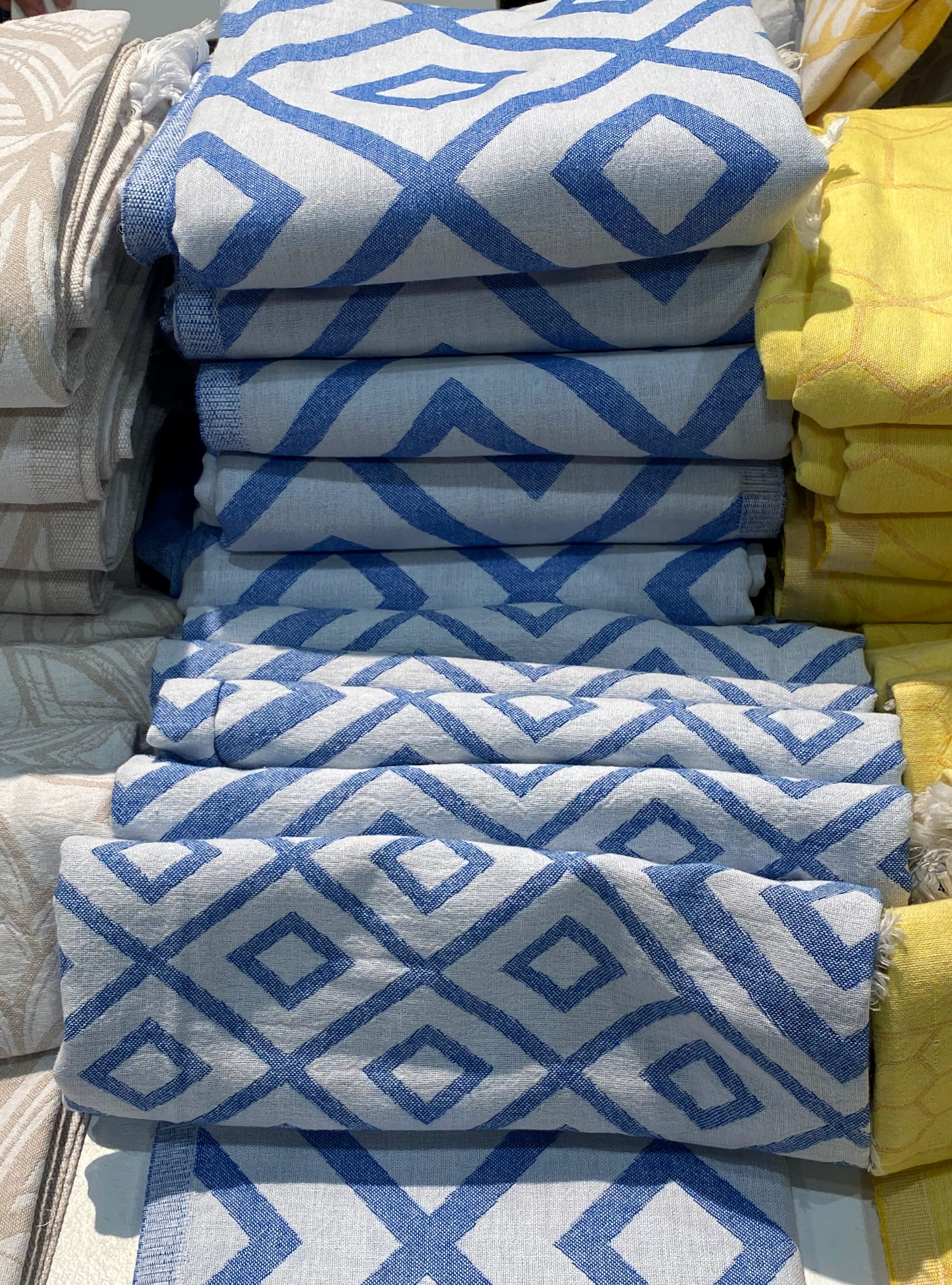 Stacked blue towels with a diamond pattern.