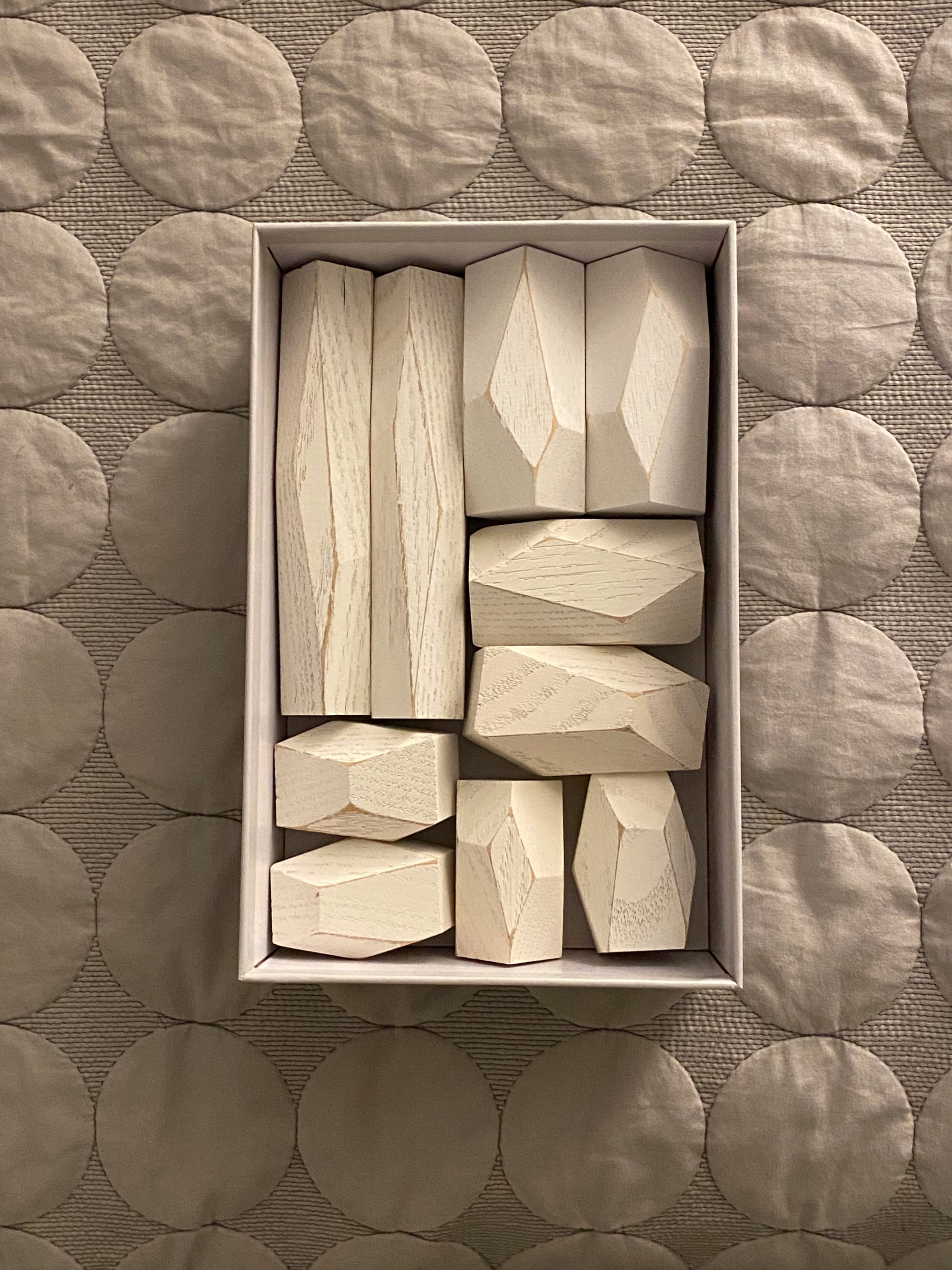 On open box showing ten stacking blocks.