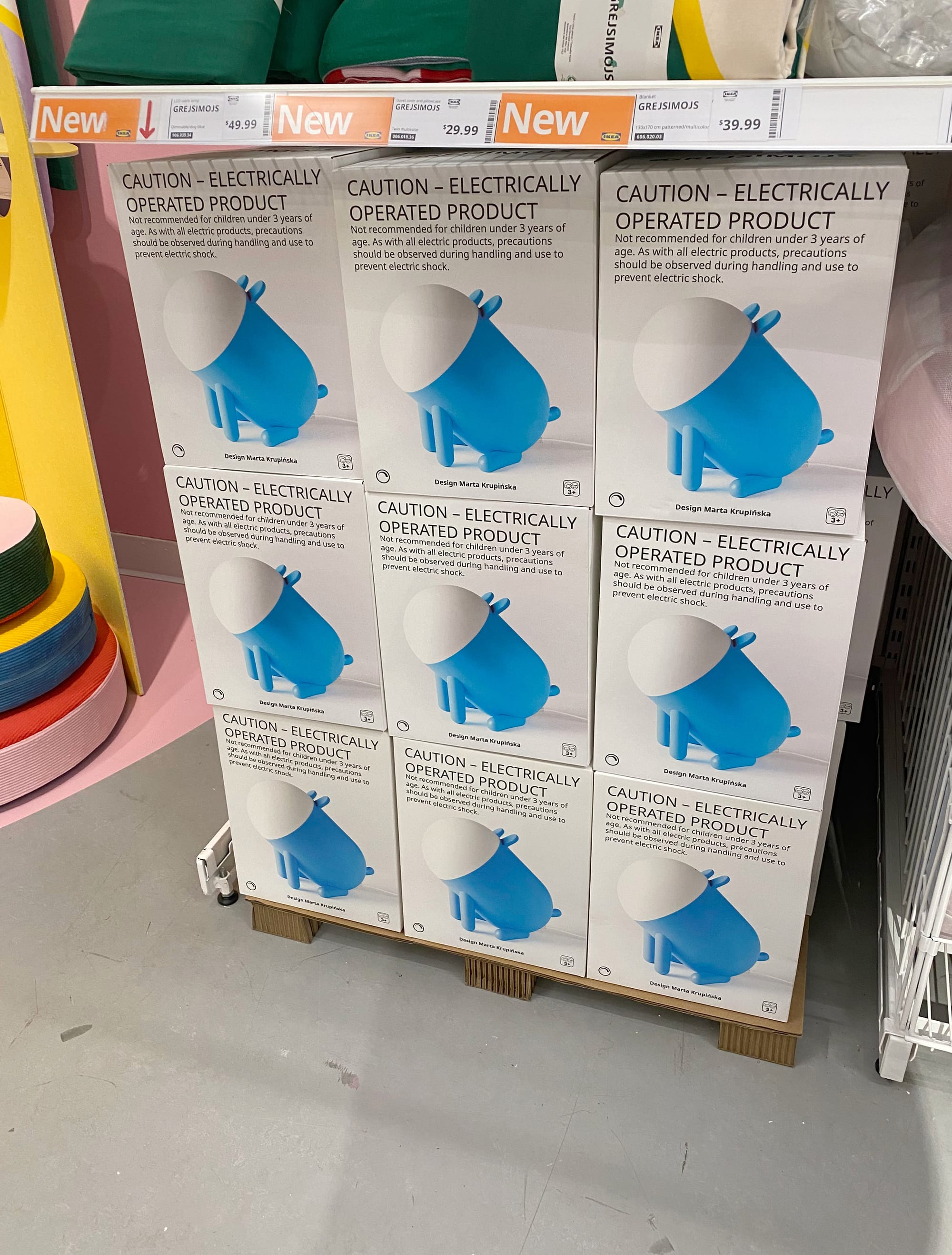 Stack of boxes, each with photo of dog lamp on the outside.