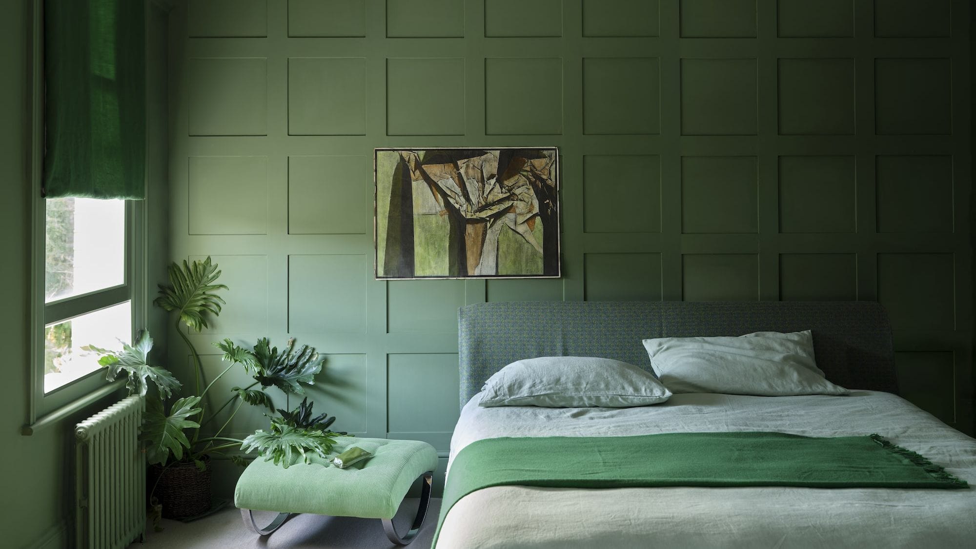 Bedroom with green walls, furniture and accessories.